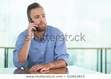 Stock foto: Thoughtful Businessman Talking On The Phone In Cafe