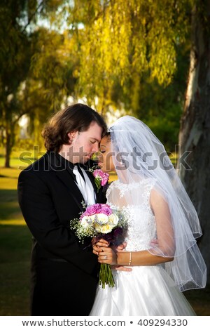 Stok fotoğraf: Mixed Race Couple Leaning Against Tree In A Romantic Moment