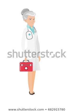 Сток-фото: Senior Caucasian Doctor Holding First Aid Box