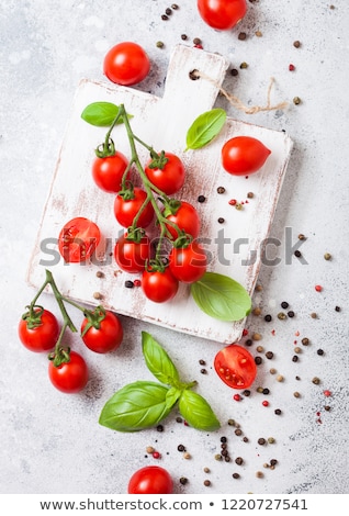 Stock photo: Organic Cherry Sugardrop Tomatoes On The Vine With Basil In Oilve Wood Plate And Spoon With Pepper O