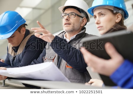 Stockfoto: Happy Young Woman Working As Architect In Construction Site