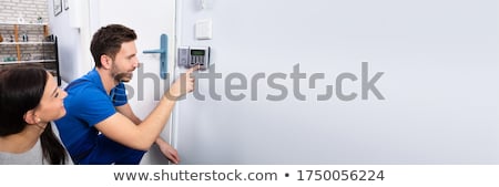 Zdjęcia stock: Handyman Installing Security System Near Door Wall