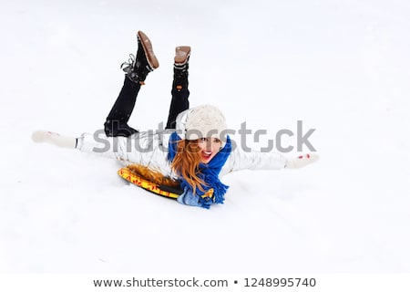 [[stock_photo]]: Girl Sliding Down On Snow Saucer Sled In Winter