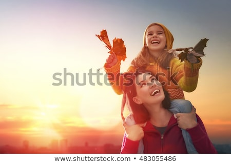 Stock fotó: Mother And Her Little Daughter Play Cuddling On Autumn Walk In N