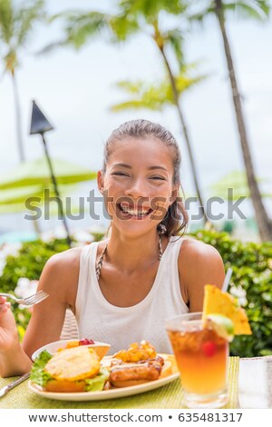 Happy Woman At Restaurant Eating Hawaii Burger With Pineapple And Karaage Fried Chicken Hawaiian Ja Stockfoto © Maridav
