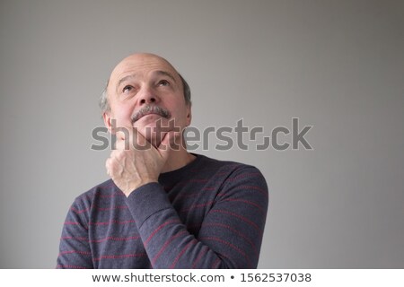 Handsome Hispanic Man Looking Upwards At Copyspace Thinking Foto stock © Koldunov