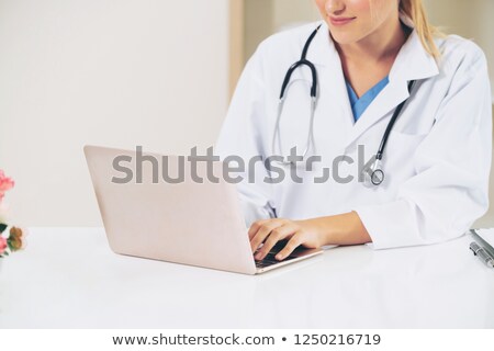 Foto stock: Smiling Female Doctor With Books