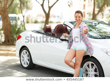 ストックフォト: Young Happy Woman Standing Near A Convertible With The Keys In H