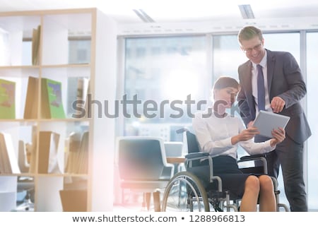 Foto d'archivio: Businessman Discussing With Colleague Over Digital Tablet