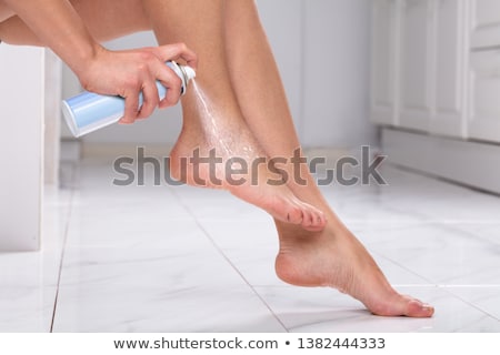 ストックフォト: Woman Spraying Relief Spray On Foot