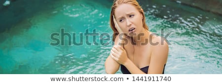 Stok fotoğraf: Woman Has An Ear Ache In The Pool Diver Ear