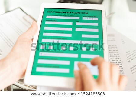 [[stock_photo]]: Healthy Insurance Claim Application In Electronic Form On Display Of Touchpad