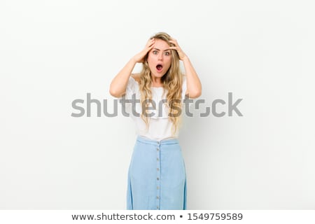 Foto stock: Young Panic Woman With Hands On The Head