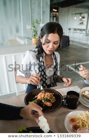 Stock foto: Young Woman And Companion Tasting Dish