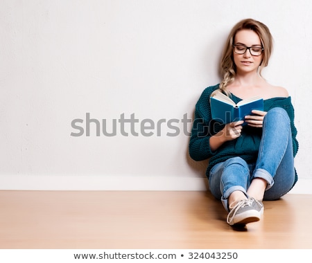 Сток-фото: Caucasian Woman Reading A Book On A Sofa