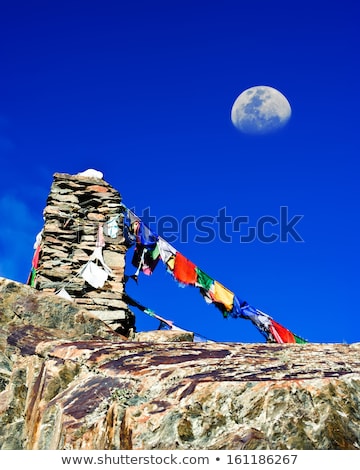 Imagine de stoc: Buddhist Stone Tower With Praying Flags And Moon At Himalaya