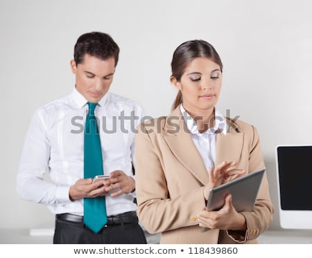 Foto stock: Two Businesspeople With Smartphone And Tablet Pc