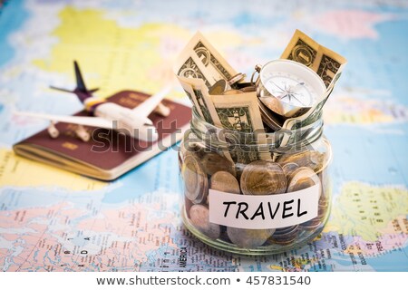 Stock photo: Travel Budget Concept Money Savings In A Glass Jar On A Map