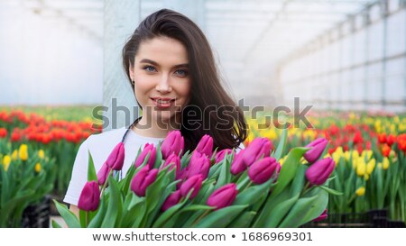 Foto stock: Smiling Woman In Hothouse