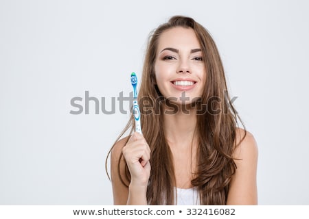 Stock photo: Young Lady Holding Toothbrush And Smiling