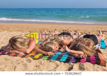 Stockfoto: Three Dutch Girls Sunbathing On Beach
