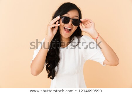 Сток-фото: Happy Asian Woman Posing Isolated Over Beige Wall Background Wearing Eyeglasses