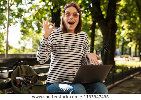 Stockfoto: Excited Happy Woman Outdoors Sitting Using Laptop Computer