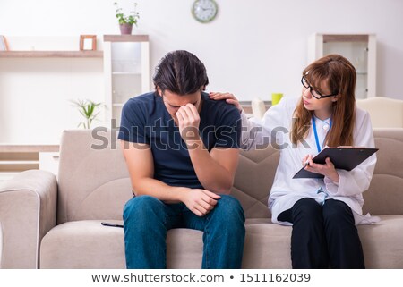 Stock foto: Young Male Patient Discussing With Female Psychologist Personal