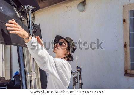 Foto stock: Gaffer Or The Chief Electrician In A Motion Picture Or Television Production Unit Set Up The Lights