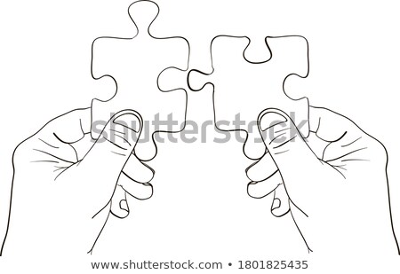 Foto d'archivio: Two People Joining The Jigsaw Puzzles