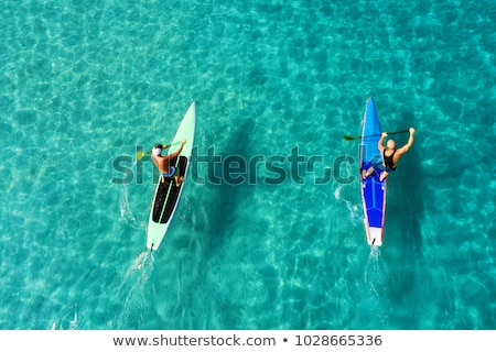 Stock photo: Strong Men Floating On A Sup Boards In A Beautiful Bay On A Sunny Day Aerial View Of The Men Crosse