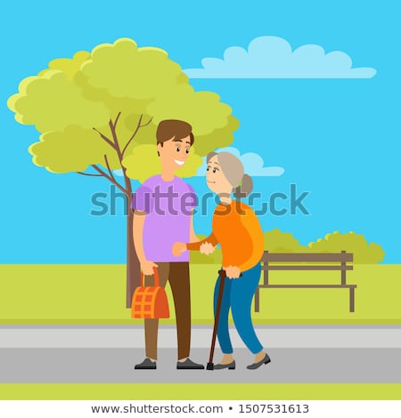 Сток-фото: Volunteer Helping Old Granny To Carry Bag In Park