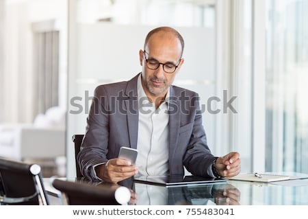 Stok fotoğraf: Mature Businessman Using A Cellphone