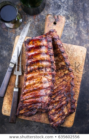 Foto stock: Ribs On A Cutting Board With Bbq Sauce