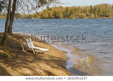 Stockfoto: Chaise Longues Near River