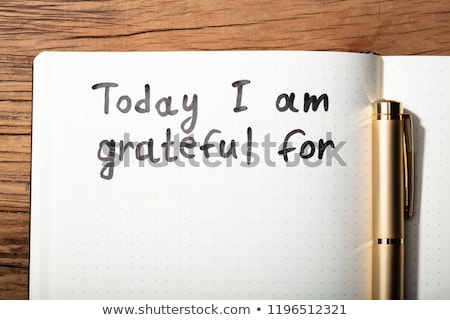 Foto stock: Gratitude Word With Pen On Notebook