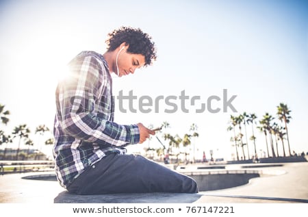 Foto stock: Man With Smartphone And Earphones In Los Angeles