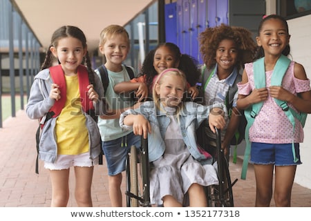 Stock photo: Front View Of A Caucasian Smiling Schoolgirl Looking At The Camera While Pretending To Be An Executi