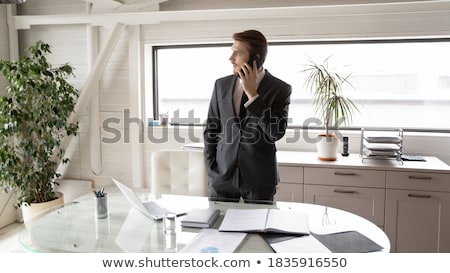 Stock foto: Succesful Male Entrepreneur In Formal Suit Holds Modern Tablet Checks Documentation Online Reads