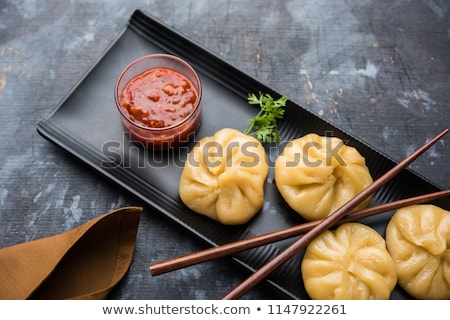 Foto stock: Traditional Dumpling Momos Food From Nepal Served With Tomato Chutney Selective Focus