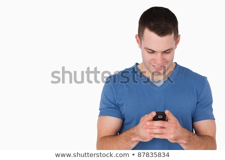 Zdjęcia stock: Smiling Man Sending Text Messages Against A White Background