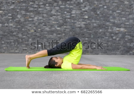 Foto d'archivio: Portrait Of Healthy Young Woman Practising Yoga Exercise On Mat
