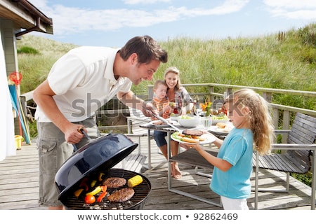 Foto stock: Family On Vacation Having Barbecue
