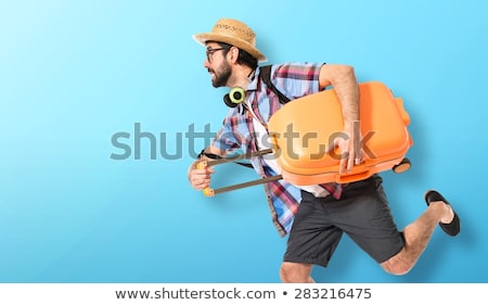 Stockfoto: Young Man Travelling With Suitcases Isolated On White