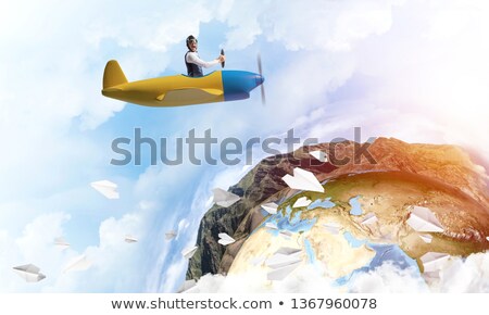 Foto stock: Airline Pilot Driving Paper Airplane