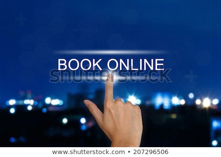 Foto stock: Hand Touching Booking Now Button