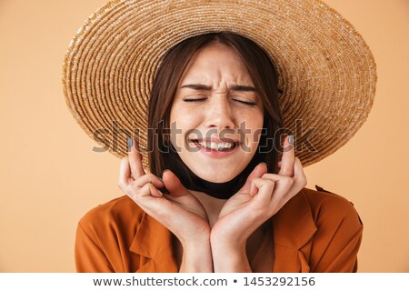 Stock photo: Portrait Of Happy Woman 20s Holding Fingers Crossed For Pray Or