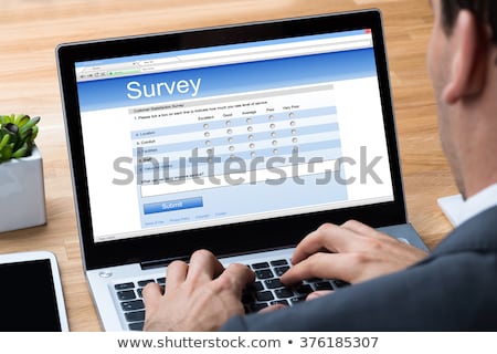 Сток-фото: Man Giving Online Survey On Laptop