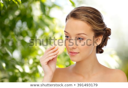 Stockfoto: Young Woman Cleaning Face With Exfoliating Sponge