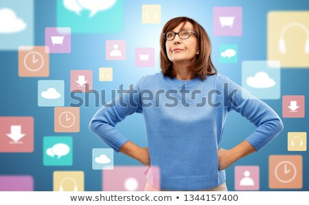 Zdjęcia stock: Displeased Senior Woman In Glasses Over App Icons